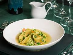 Tortellini with scallops, beans, herbs in seafood consommé