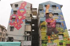 Colourful murals cover old buildings in HCM City