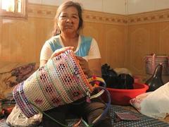 Disabled woman makes baskets from waste bottles